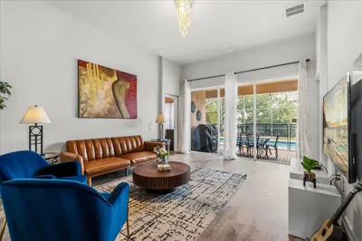a living room with a couch and a table at Large Family Retreat Pool BBQ Disney Parks Nearby in Orlando
