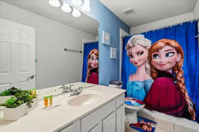 a bathroom with a sink and a shower curtain with barbie at Large Family Retreat Pool BBQ Disney Parks Nearby in Orlando