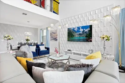 a living room with a couch and a table at Bright Pool Villa Gated Resort Disney Shuttle Nearby in Kissimmee