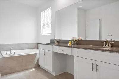 a white bathroom with a sink and a tub at Bright Pool Villa Gated Resort Disney Shuttle Nearby in Kissimmee