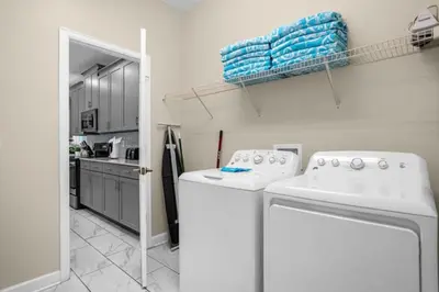 a kitchen with a washer and dryer in a room at Stylish Resort Home Game Room Poo Near Disney in Kissimmee