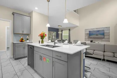 a large kitchen with a sink and a couch at Stylish Resort Home Game Room Poo Near Disney in Kissimmee