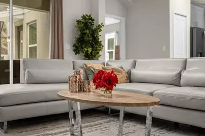 a living room with a couch and a table at Stylish Resort Home Game Room Poo Near Disney in Kissimmee