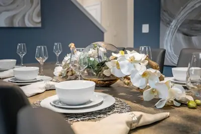 a table with white flowers and plates and wine glasses at Stylish Resort Home Game Room Poo Near Disney in Kissimmee