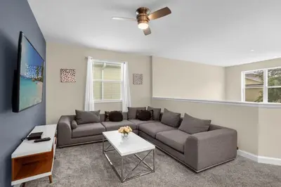 a living room with a couch and a table at Stylish Resort Home Game Room Poo Near Disney in Kissimmee