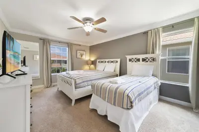 a bedroom with two beds and a ceiling fan at Disney Staycation Pool, Fun Resort Access in Kissimmee