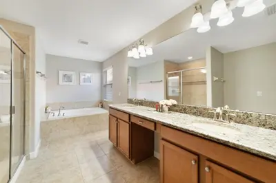 a large bathroom with two sinks and a tub at Disney Staycation Pool, Fun Resort Access in Kissimmee