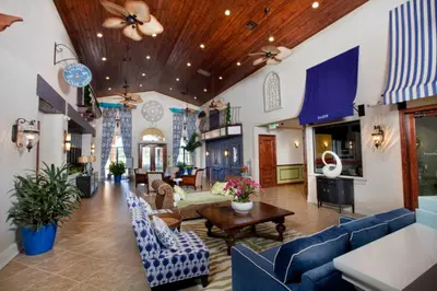 a living room with blue couches and a table at Disney Staycation Pool, Fun Resort Access in Kissimmee