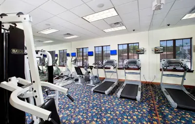 a gym with rows of treadmills and machines at Disney Staycation Pool, Fun Resort Access in Kissimmee