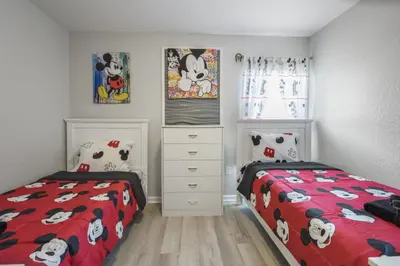 a bedroom with two twin beds with hello kitty sheets at Bright Resort Home Pool Near Disney in Orlando