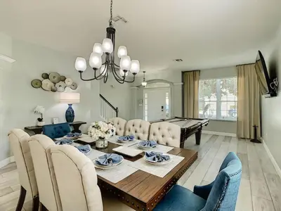 a dining room with a table and chairs and a dining room at Modern 6BR Resort Private Pool Near Disney in Orlando