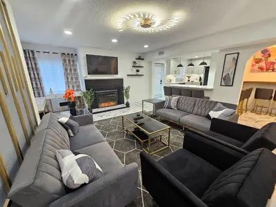 a living room with couches and a fireplace at Stylish Duplex walkTO Lake Eola Orlando. Sleeps 8 in Orlando