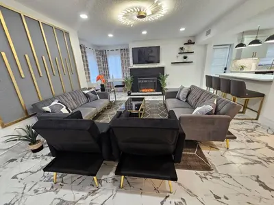 a living room with couches and a fireplace at Stylish Duplex walkTO Lake Eola Orlando. Sleeps 8 in Orlando