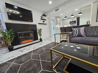 a living room with a couch and a fireplace at Stylish Duplex walkTO Lake Eola Orlando. Sleeps 8 in Orlando