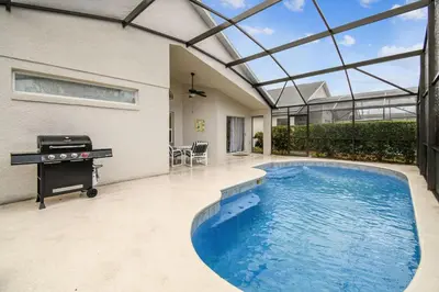a swimming pool in a house with a piano at Casa c/ Piscina Privativa e Game Room in Kissimmee