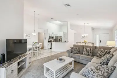 a living room with a couch and a table at Casa c/ Piscina Privativa e Game Room in Kissimmee