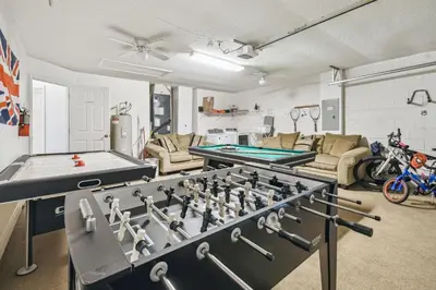 a living room with a pool table and ping pong tables at Casa c/ Piscina Privativa e Game Room in Kissimmee