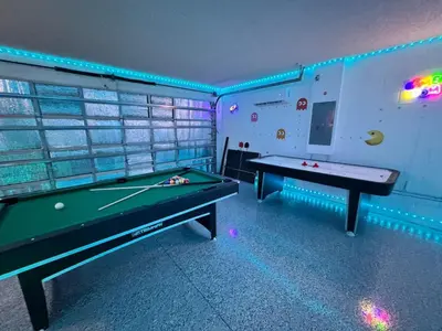 two pool tables in a gaming room with lights at Casa Kissimmee in Orlando