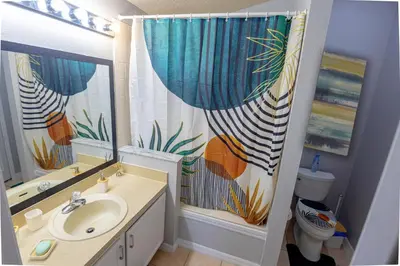 a bathroom with a sink and a shower curtain at Casa Kissimmee in Orlando