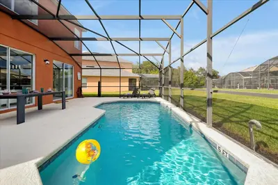 a swimming pool with a ball in a backyard at Family-Friendly 6-Bedroom Villa with Pool Game Room and Themed Bedrooms at Emerald Island Resort in Kissimmee