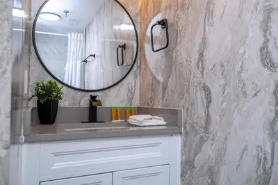 a bathroom with a sink and a mirror at Modern 2BR Near Universal in Orlando