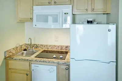 a kitchen with a white refrigerator and a microwave at Wyndham Star Island Resort-1BR- Apartment with Resort Access in Kissimmee
