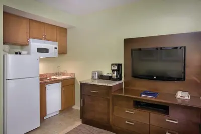 a kitchen with a white refrigerator and a tv at Wyndham Star Island Resort-1BR- Apartment with Resort Access in Kissimmee