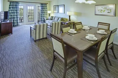 a living room with a table and chairs and a couch at Wyndham Star Island Resort-1BR- Apartment with Resort Access in Kissimmee