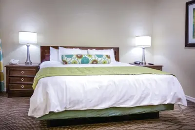 a bedroom with a large bed with two lamps at Wyndham Star Island Resort-2BR- Apartment with Resort Access in Kissimmee