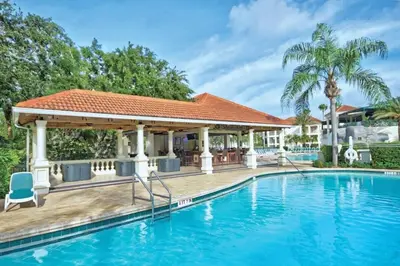 a swimming pool with a gazebo next to a house at Wyndham Star Island Resort-2BR- Apartment with Resort Access in Kissimmee