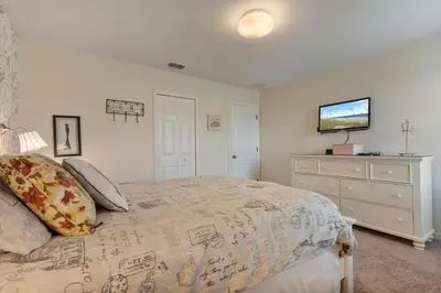 a bedroom with a large bed and a dresser at 4BR Lake View Home Bella Vida in Kissimmee