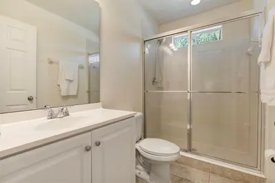 a bathroom with a toilet sink and a shower at 4BR Lake View Home Bella Vida in Kissimmee