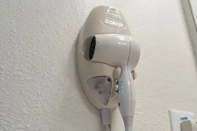a hair dryer is hanging on a wall at 4BR Lake View Home Bella Vida in Kissimmee