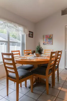 a dining room with a wooden table and chairs at 15 Mins Disneyworld Private Pool & Game Room in Kissimmee