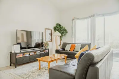 a living room with a couch and a table at 15 Mins Disneyworld Private Pool & Game Room in Kissimmee