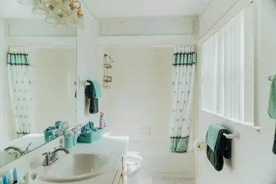 a white bathroom with a sink and a shower at 15 Mins Disneyworld Private Pool & Game Room in Kissimmee