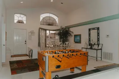 a room with a foosball table in the middle at 15 Mins Disneyworld Private Pool & Game Room in Kissimmee