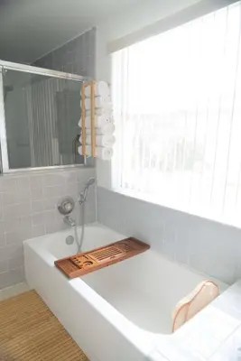a bathroom with a bath tub with a window at 10 min to Disney | Karaoke | Game in Kissimmee