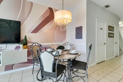 a dining room with a table and chairs at Family-Friendly Resort Getaway 5 Mi to Disney! in Kissimmee