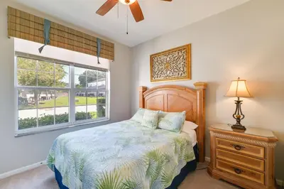 a bedroom with a bed and a window at Pool and Resort Perks Family Retreat Near Disney! in Kissimmee