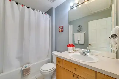 a bathroom with a sink and a toilet and a shower at Pool and Resort Perks Family Retreat Near Disney! in Kissimmee