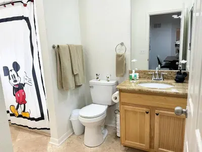 a bathroom with a toilet and a sink at 2BR Condo Close to Disney - Gated, Pool & Hot Tub in Kissimmee