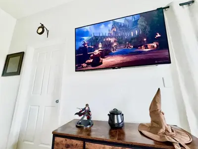 a flat screen tv hanging on a wall at 2BR Condo Close to Disney - Gated, Pool & Hot Tub in Kissimmee