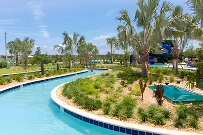 a pool at a resort with palm trees at Casa Familiar 10min da Disney + Piscina Privativa in Kissimmee