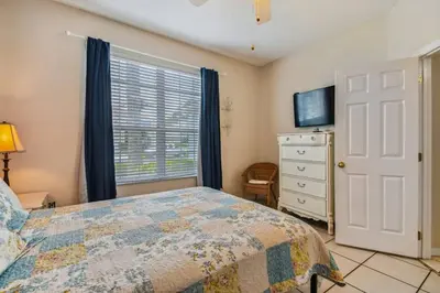 a bedroom with a bed and a window and a dresser at Casa 4Q no Lake Berkley c/ Piscina Privativa in Kissimmee