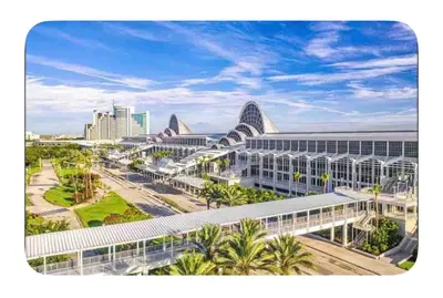a view of a large building with palm trees and buildings at Modern 2 Bedrm Apartment with fast Wi-fi - Apartment in Orlando
