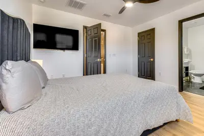 a bedroom with a bed and a tv on the wall at Modern Resort Getaway 9 Mi to Disney Parks! in Kissimmee