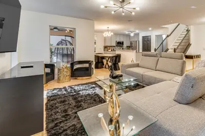 a living room with a couch and a table at Modern Resort Getaway 9 Mi to Disney Parks! in Kissimmee