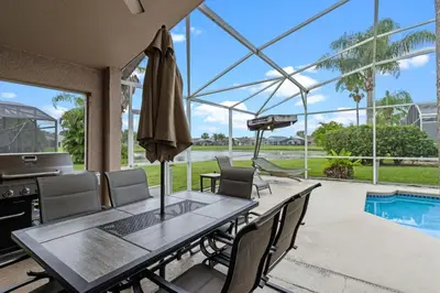 a dining room with a table and chairs and a pool at Orlando Family Retreat 4BR, Private Pool and Lake in Kissimmee