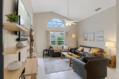 a living room with a couch and a table at Orlando Family Retreat 4BR, Private Pool and Lake in Kissimmee